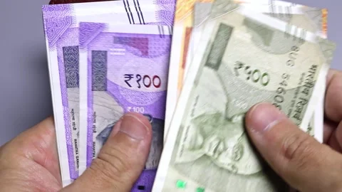 Closeup view of man's hands and wallet with indian rupees banknotes. Stock Footage 302245860