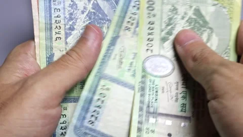Closeup view of man's hands and wallet with Nepalese rupees banknotes. Stock Footage 302263282