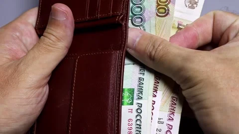 Closeup view of man's hands and wallet with russian rubles banknotes. Stock Footage 302271766