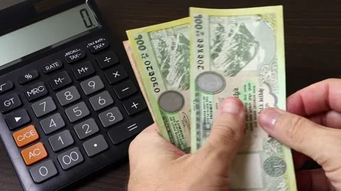 Closeup view of man's hands counting Nepalese rupee (NPR) cash money banknotes. Stock Footage 303579682