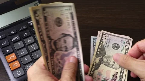 Closeup view of man's hands counting American dollar (USD) cash money banknotes. Stock Footage 303580263