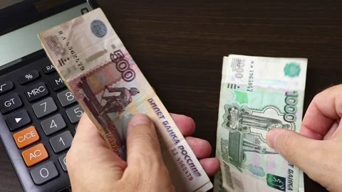 Closeup view of man's hands counting Russian ruble (RUB) cash money banknotes. Stock Footage 303580367