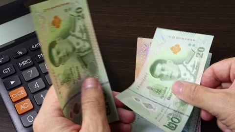 Closeup view of man's hands counting Thai baht (THB) cash money banknotes. Stock Footage 303580568
