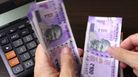 Closeup view of man's hands counting Indian rupees (INR) cash money banknotes. Stock Footage 303580965