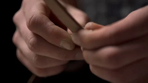 Closeup view of man's hands folding pieces of leather in the workshop Stock Footage 71485250