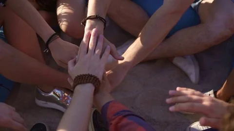 Closeup view of many hands united together and raised up. Teamwork and Stock Footage 76718559