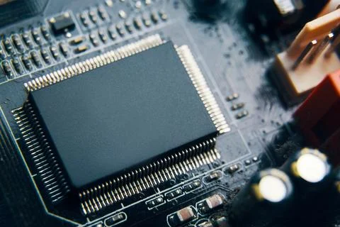 A CloseUp View of a Microchip Seated on a Circuit Board with Various Stock Photos