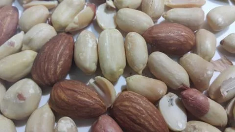Closeup view of mixed dried and roasted  peanuts and almonds. A fruit for bac Stock Photos