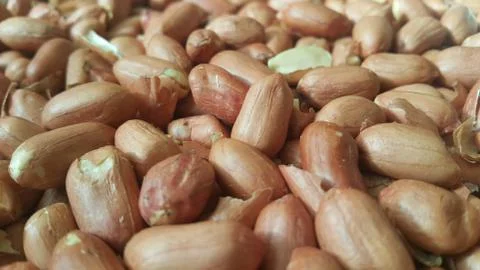 Closeup view of mixed, dried, roasted  peeled and unpeeled peanuts. A fruit f Foto stock