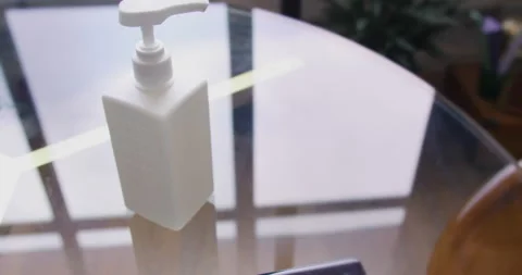 Closeup view mobile phone on the table and alcohol sanitizer bottle. Healthcare Video stock 132013411