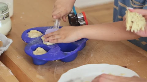 Closeup view of mom, child making pastry and sitting at table in home kitchen Stock Footage 161122233