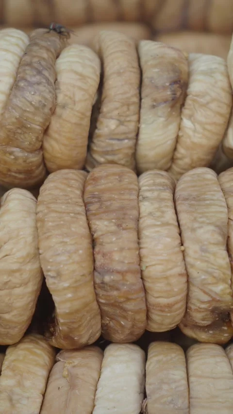A CloseUp View of Natural Dried Fig Rolls Stacked Neatly Together, Showcasing Stock Footage 283154447