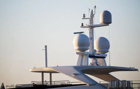 Closeup view of navigation radar system antennas yacht on blue sky background Stock Photos