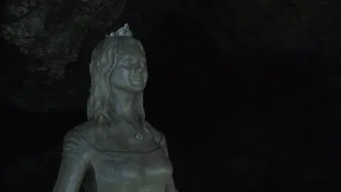 Closeup view of an old, beautiful statue of a woman which is located in a cav Stock Footage 132962580