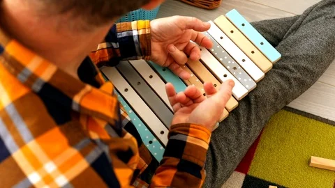 Closeup view of old man hands playing music on colorful kids xylophone, playing 스톡 동영상 120067006
