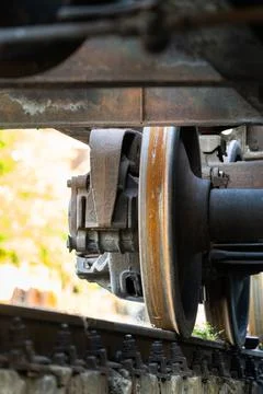 Closeup view of old rusty wheels of train. Railroad car chassis on rail. Stock-Fotos