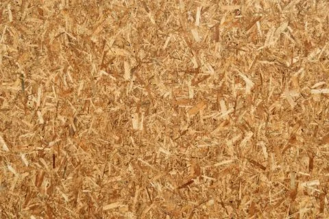 Closeup view of oriented strand board (OSB) surface with chaotic wood chips Foto stock