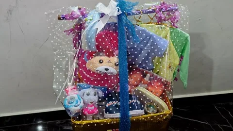 Closeup view of packed gift for kid with colorful wrapping and ribbon decor.. Stock Footage 335874021