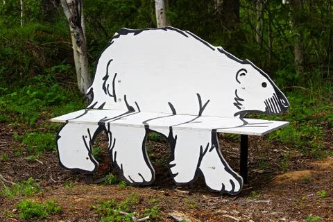 A closeup view of a park bench in the shape of a polar bear Stock Photos