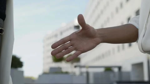 Closeup view of partners shaking hands and making deal in city Stock Footage 97446053