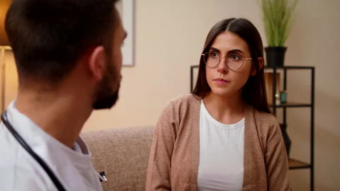 Closeup View On Patient Which Talking At During Home Visit With Male Doctor Stock Footage 146995998