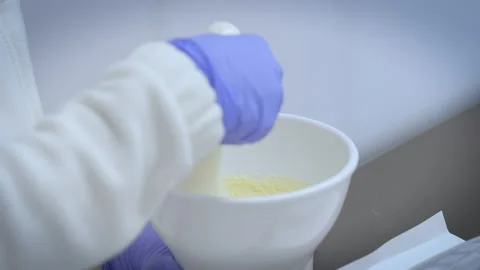 Closeup view of a pharmacist's hands using mortar and pestle. Stock Footage 238507004
