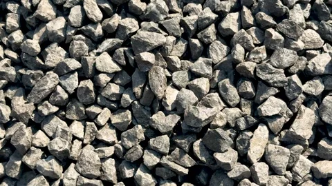 Closeup view of a pile of gray stones with rough textures and varied shapes.. Vídeos de archivo 339368890