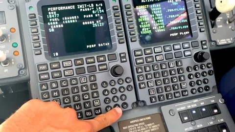 Closeup view of a pilot checking the flight management system to verify 库存影片 115453016