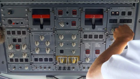 Closeup view of a pilot operating the test switches located on the Stock Footage 117606933