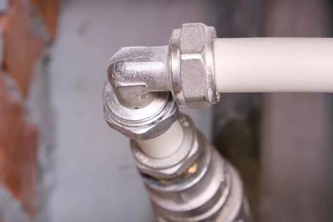 This is a closeup view of a pipe that has a broken elbow joint Stock Photos