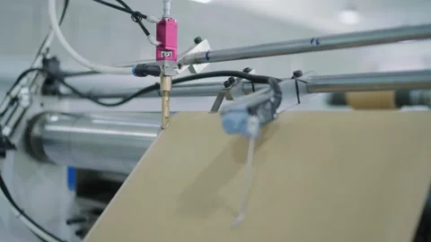 Closeup view of printing materials on roller belt at printing factory in Stock Footage 313577228