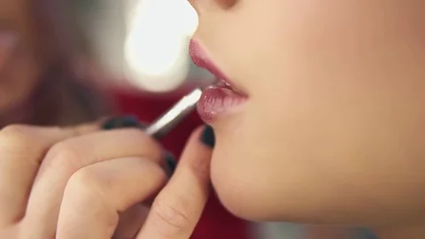 Closeup view of a professional makeup artist's hand using special brush to apply Stock Footage 83165391