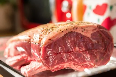 Closeup view raw beef cross rib chunk on oven tray with foil Photos
