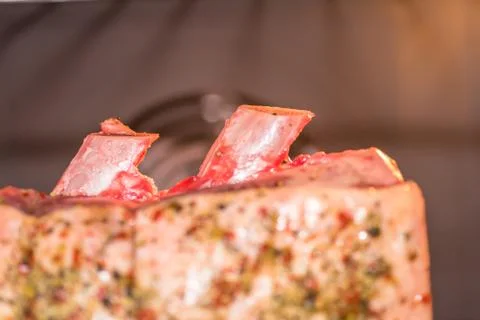 Closeup view raw beef cross rib chunk on oven tray with foil inside oven Stock-Fotos