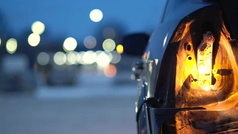 Closeup view of rear light of broken car with bokeh lights of night city Stock Footage 329525800