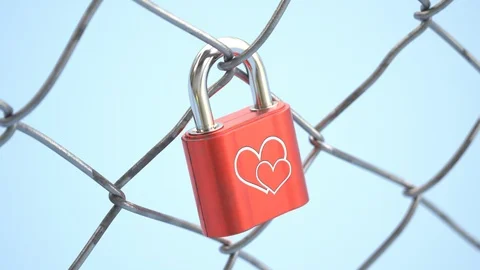 Closeup view at the red padlock with heart hanging on fence. Bridge. Love. 4k HD 動画素材 126253539
