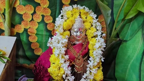 Closeup view of religious goddess idol adorned with colorful flowers in a s.. Stock Footage 335873884