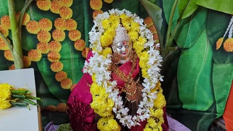 Closeup view of religious idol adorned with colorful flowers in a sacred se.. Stock Footage 335873947