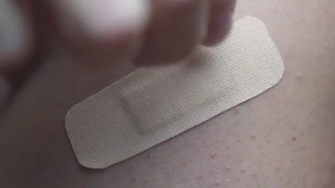 Closeup view of removing an adhesive plaster from a wound Stock Footage 309978518