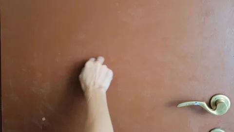 Closeup view of right hand man knocking using index finger on the brown woo.. Stock Footage 283061581