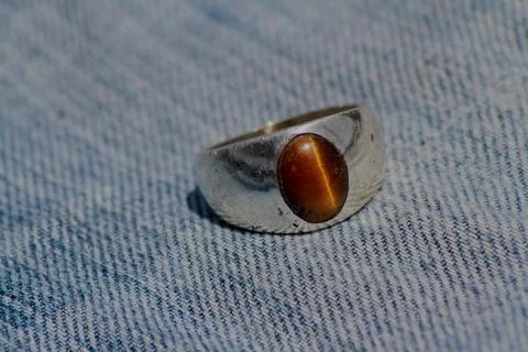 Closeup view of a ring with tiger's eye gemstone in it Stock Photos