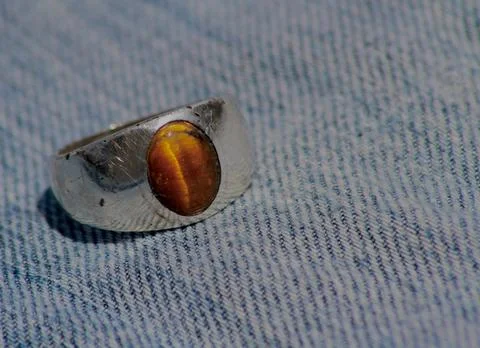 Closeup view of a ring with tiger's eye gemstone in it Stock Photos
