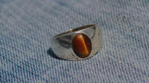 Closeup view of a ring with tiger's eye gemstone in it Stock Photos