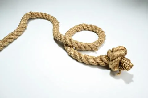 Closeup view of ropes string with a knot isolated over a white background Stock Photos