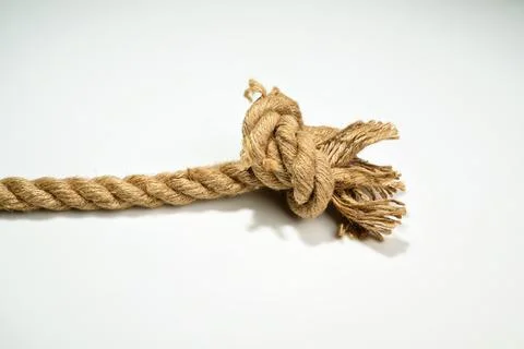 Closeup view of ropes string with a knot isolated over a white background Stock Photos