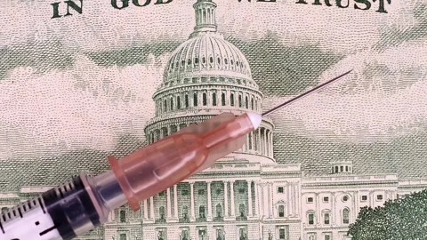 Closeup view of rotating syringe and brand new 50 USD american dollars banknote. Stock Footage 297233093