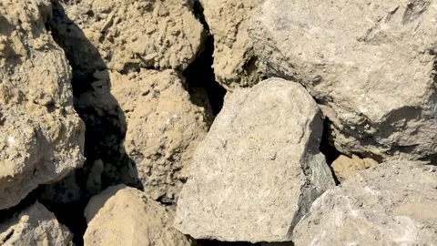 Closeup view of rugged, textured stones in natural earthy tones under brigh.. Stock Footage 339425585