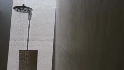 Closeup view of running water from head of shower at bathroom. Stock Footage 181418090