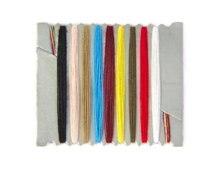 Closeup view of sewing threads multicolored on white background Stock Photos