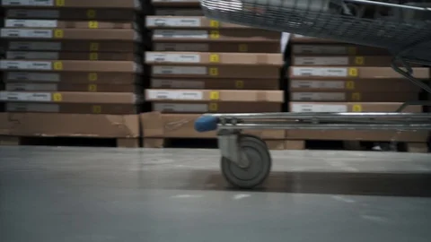 Closeup view on a shopping trolley is riding on the floor in store Stock Footage 88639583